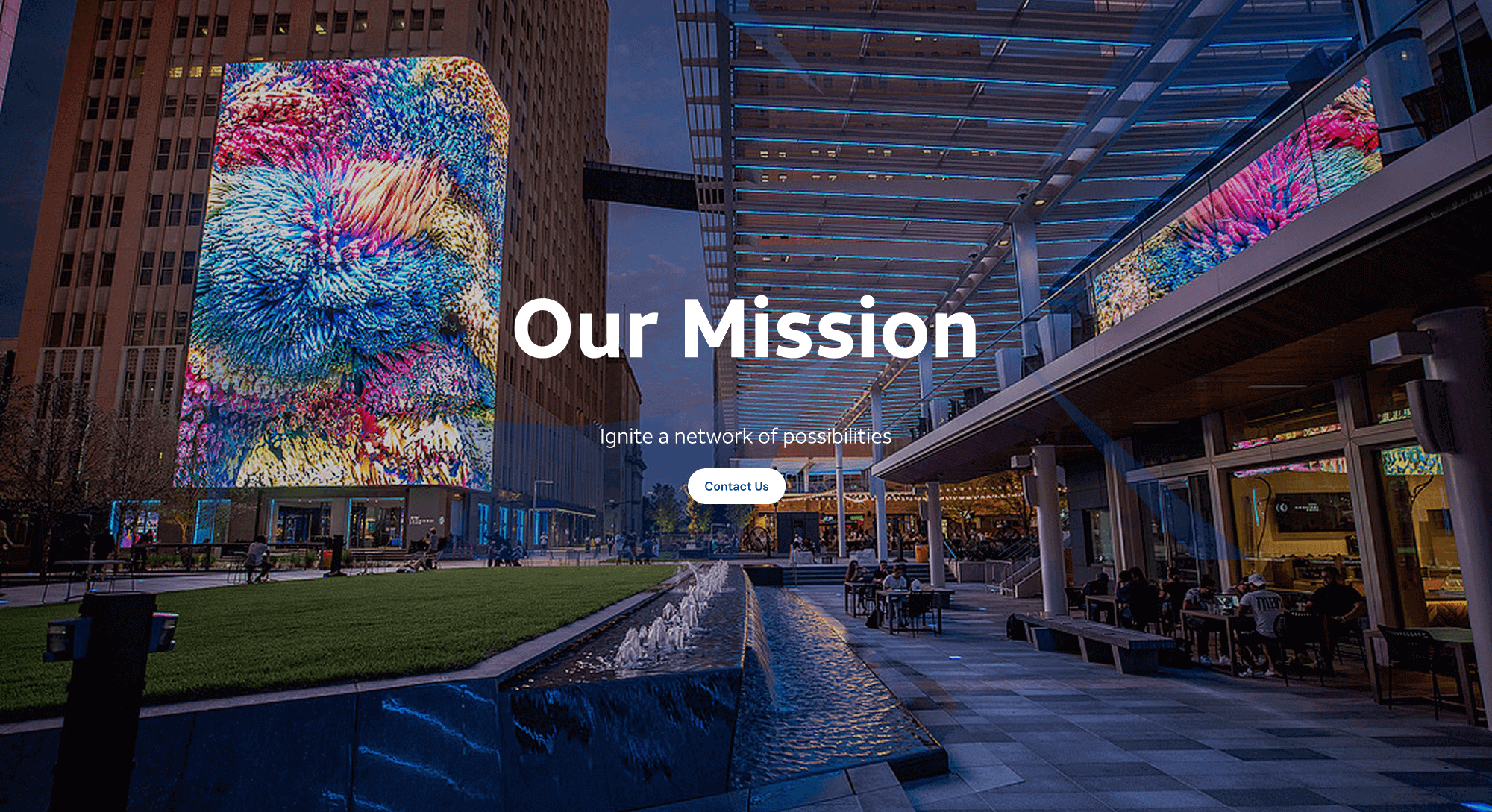 MVNX About Header - Picture of AT&T Discovery District in Dallas, TX overlaid with text that says "Our mission - Ignite a network of possibilities"